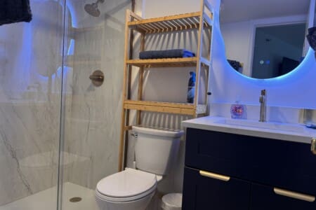 Bathroom with plenty of shelving for you goodies for date nights