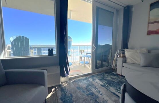 living room looking out over the ocean, beach, and the pool.
