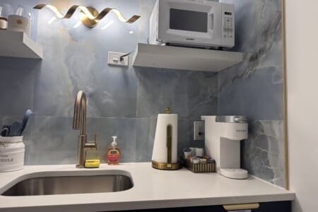 we have since bought a microwave cart and the microwave is now next to the refrigerator for easier use.